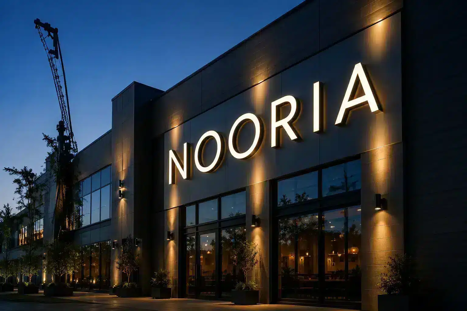 Illuminated letters across a building facade at dusk