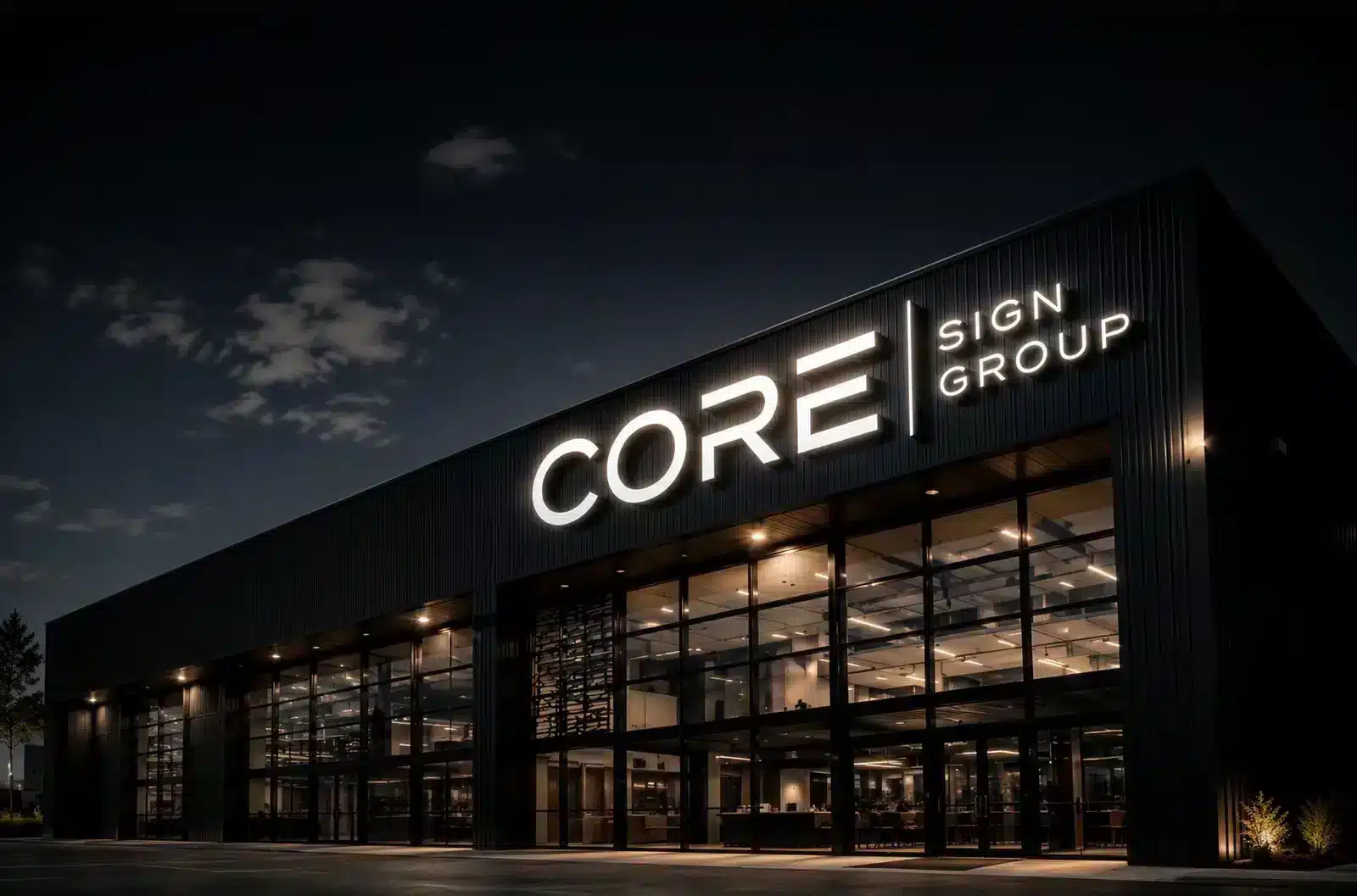 Illuminated building sign on a commercial storefront at night