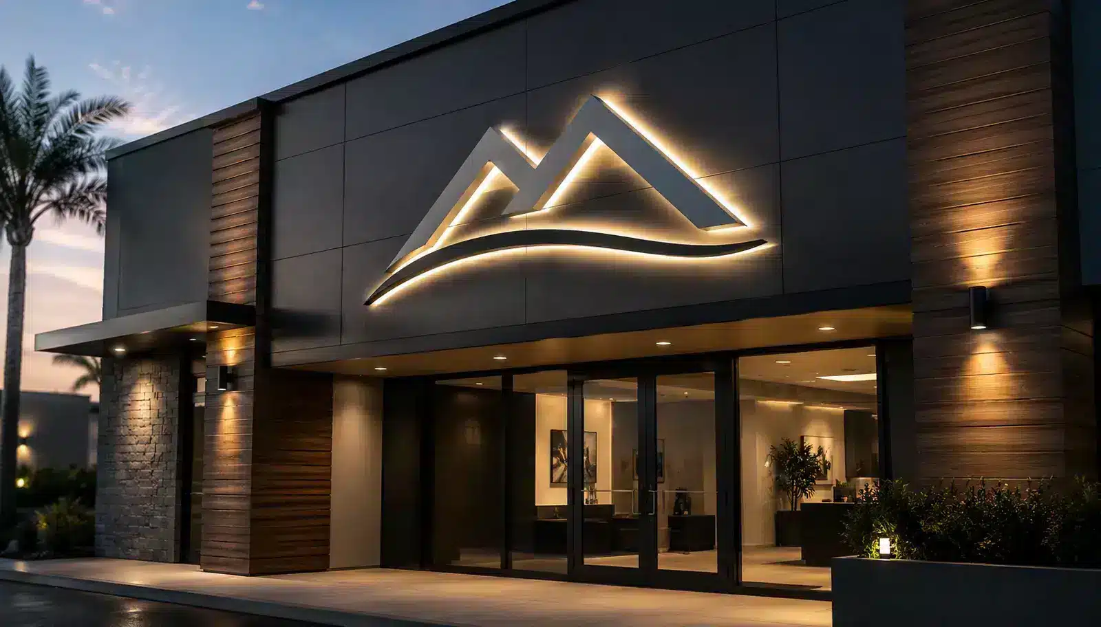 Halo-lit logo sign on a dark building facade