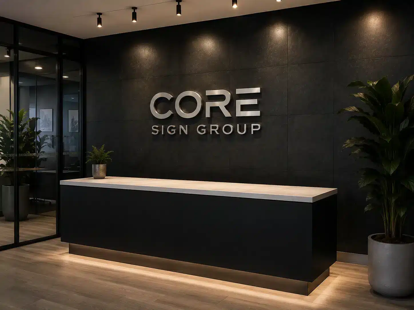 Backlit logo behind a reception desk in an office lobby