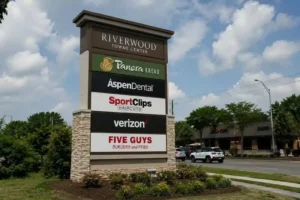 Tall pylon sign with tenant panels at a retail center